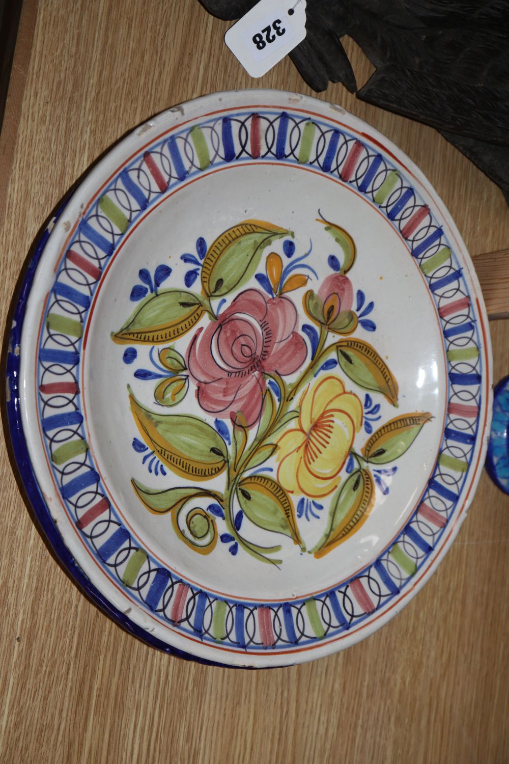 Three tin glazed earthenware dishes and a Persian stone paste vase, height 39cm